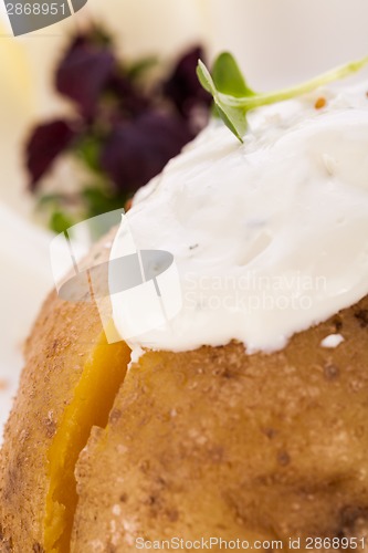 Image of Baked jacket potato with sour cream sauce