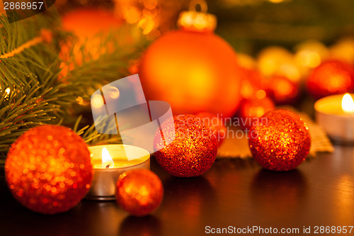 Image of Warm gold and red Christmas candlelight background