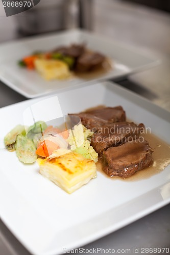 Image of Chef plating up food in a restaurant