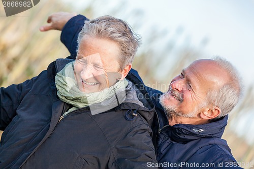 Image of Elderly couple embracing and celebrating the sun