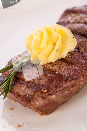 Image of Grilled beef steak topped with butter and rosemary