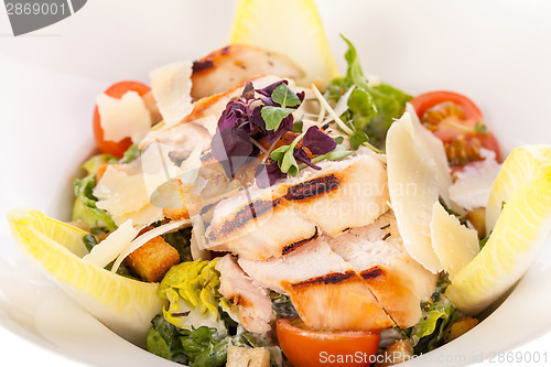 Image of tasty fresh caesar salad with grilled chicken and parmesan 