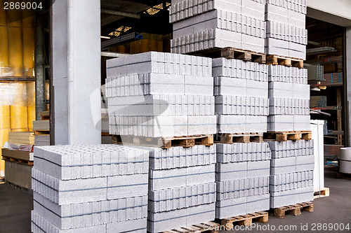 Image of Red clay bricks stacked on pallets