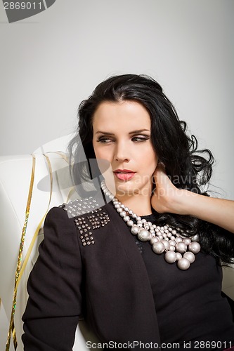 Image of Seductive brunette holding a glass of champagne