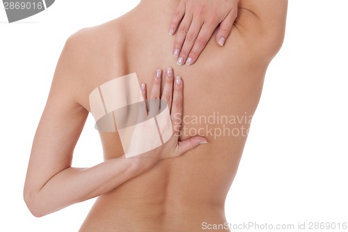 Image of Woman caressing her bare shoulder and back