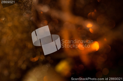 Image of Warm gold and red Christmas candlelight background