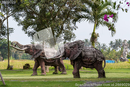 Image of Elephant statue standing on a lawn at a park