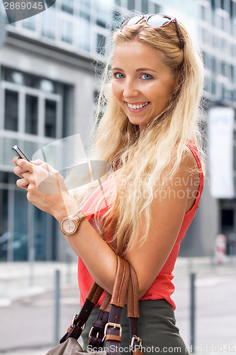 Image of Girl smiling while texting