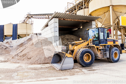 Image of Parked pay loader near pile of dirt
