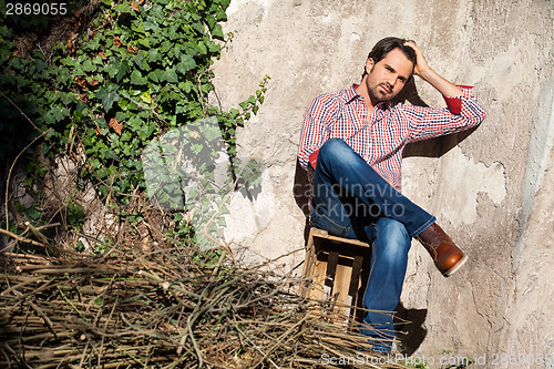 Image of Male model sitting with legs crossed