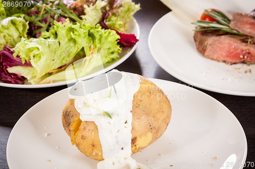 Image of Baked jacket potato with sour cream sauce