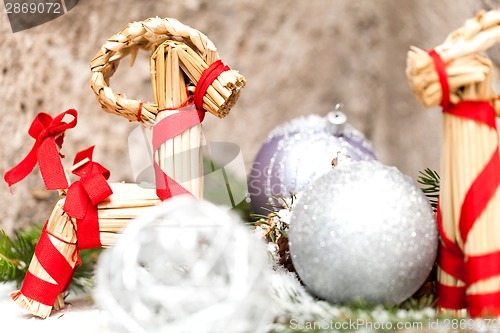 Image of Silver Christmas bauble on a tree with snow