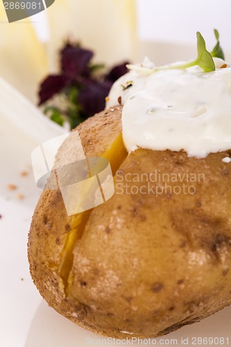 Image of Baked jacket potato with sour cream sauce