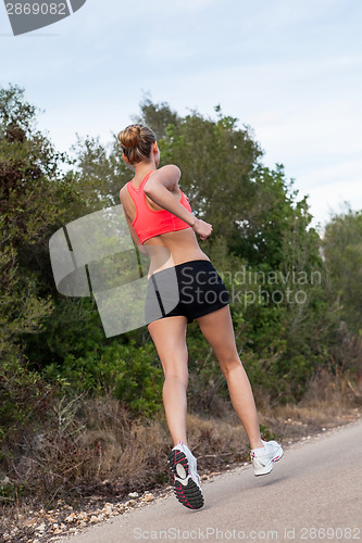 Image of Fit young woman jogging