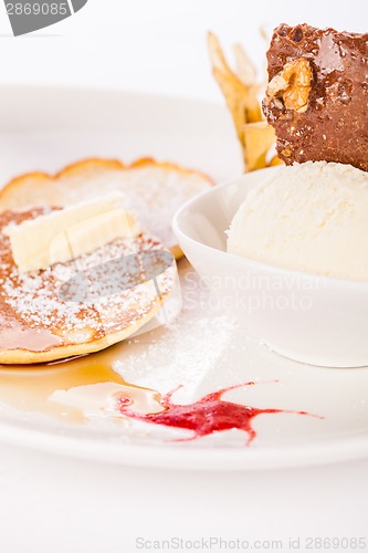 Image of tasty sweet pancakes with vanilla icecream and topping