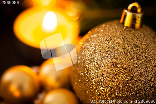 Image of Warm gold and red Christmas candlelight background