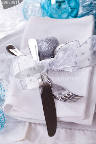 Image of Stylish blue and silver Christmas table setting