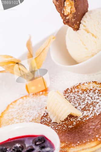 Image of tasty sweet pancakes with vanilla icecream and topping