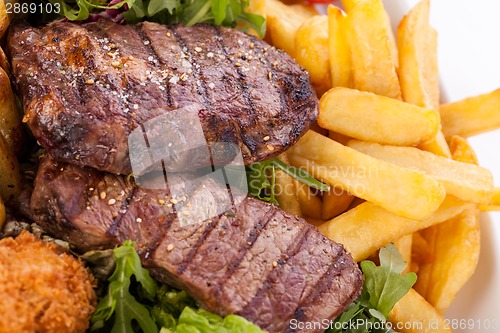 Image of Platter of mixed meats, salad and French fries