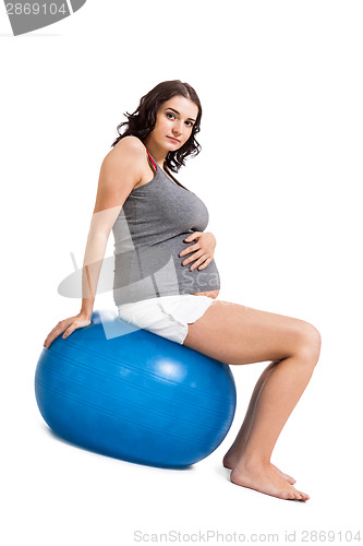 Image of Pregnant woman doing pilates exercises