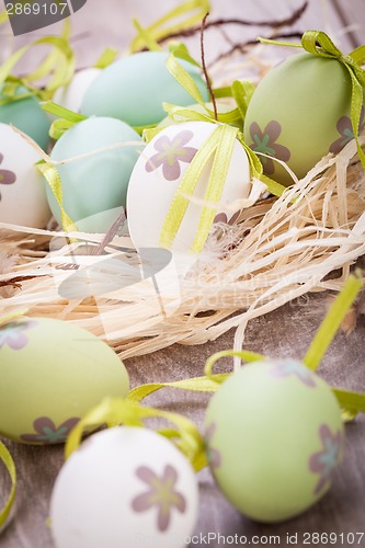 Image of Colourful green Easter eggs in straw