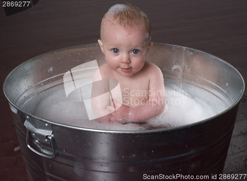 Image of Confident Infant in Bubble Bath Looking Straight at the Camera