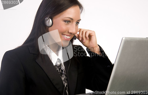 Image of Customer Service Woman Works on Computer While Talking With Head