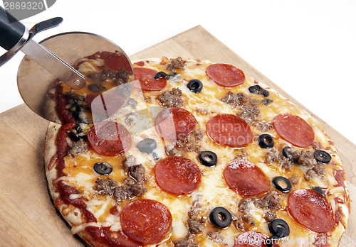 Image of Home Backed on Wood Board Cutter Slicing Meat Pizza