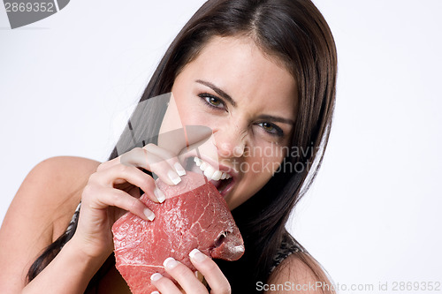 Image of Young Brunette Woman Gnaws Big Raw Food Steak Meat