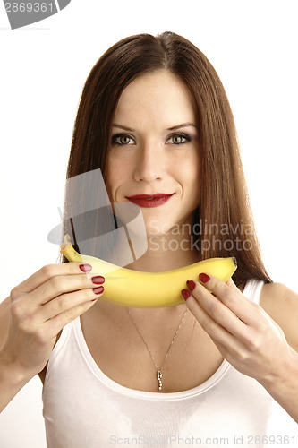 Image of Banana Showing in Manicured Hands of Beautiful Brunette Woman