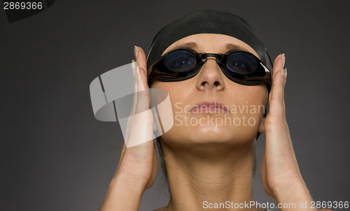 Image of Swimmer Adjusts Her Goggles Before a Dive