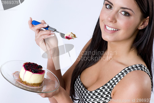 Image of Beautiful Youthful Woman eats Cheescake Dessert