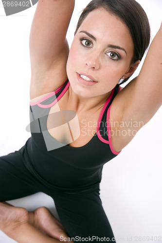 Image of Stretching Woman Reaches for the Ceiling in Yoga Practice