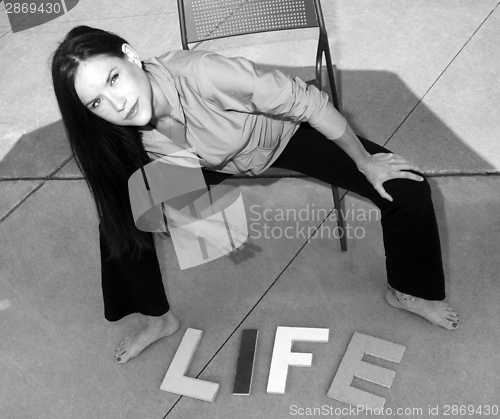 Image of Attractive woman on concrete Above the Word Life in Block Letter