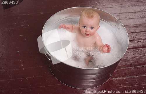 Image of Infant Taking Bubble Bath in Big Round Galvanized Tub