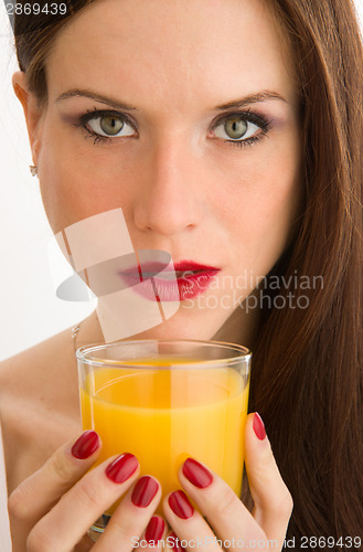 Image of Healthy Drink Beautiful Woman Looks at Camera Holding Juice