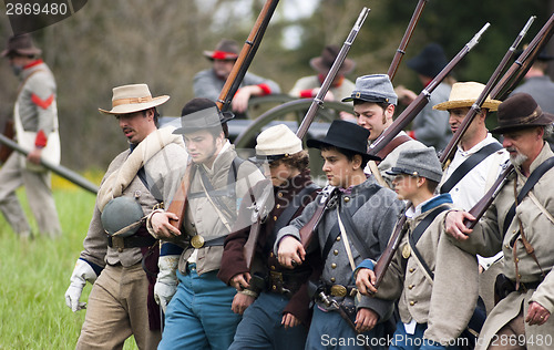 Image of Civil War Re-enactment Union Soldiers March Holding Muskets Duri