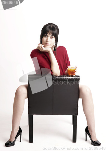Image of Brunette Female Straddles Chair Seemingly Asking you to Have a D
