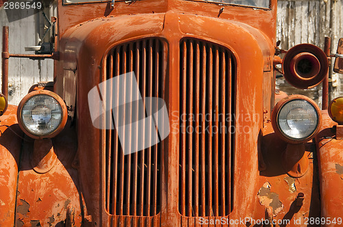 Image of Old Orange Vinatge Fire Truck Sits Rusting in Desert Country