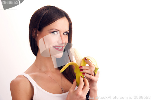 Image of Attractive Woman eats RAW food fruit banana white background