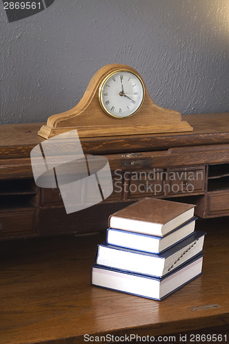Image of Books on the Antique Rolltop Desk with Mantle Clock