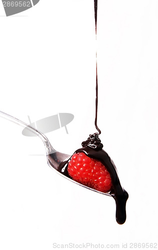 Image of sweet fruit strawberry in chocolate syrup on silver spoon