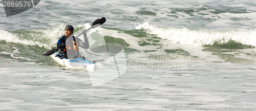 Image of Man Sea Kayak Rides Pacific Ocean Wave into Oregon Shore