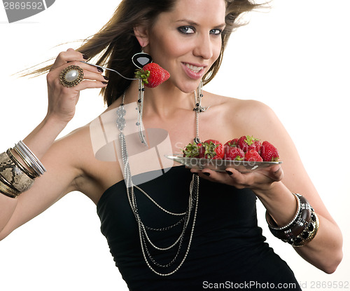 Image of Woman eats RAW fruit Food Strawberries from Glass Plate