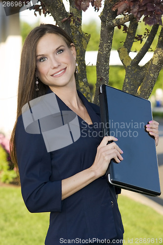 Image of Business Woman Holds Laptop