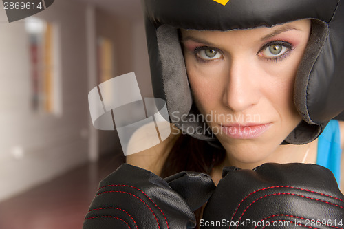 Image of Serious Female Boxer Looks Right at Camera in Close up