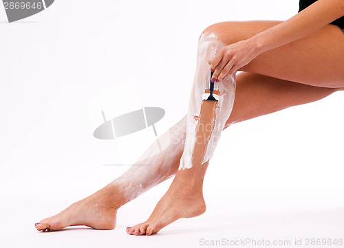Image of Woman Shaving Her Legs Silky Smooth with Man's Razor