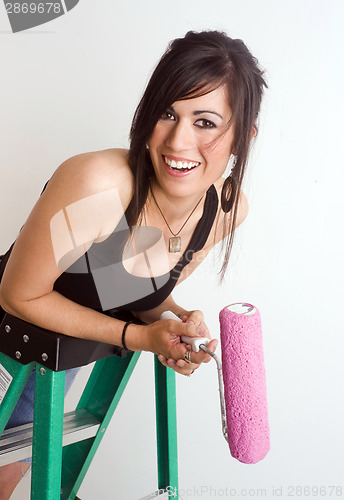 Image of Woman Pauses on Ladder to Smile at the Viewer