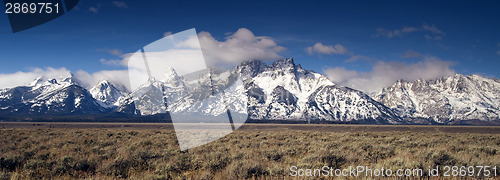 Image of Jagged Peaks Grand Teton Wyoming Bright Sun Snow Clouds