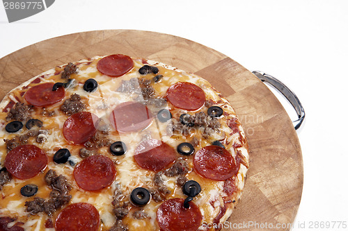 Image of Fresh Backed Supreme Pizza on Wood Cutting Board